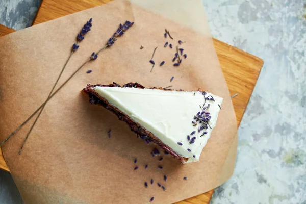 Lavender cake. Gray textured background. Beautiful serving dishes. Dessert. Food chain