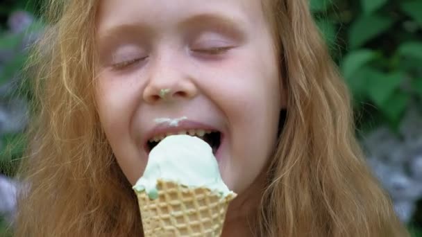 Little girl eats ice cream outdoors. Summer — Stock Video