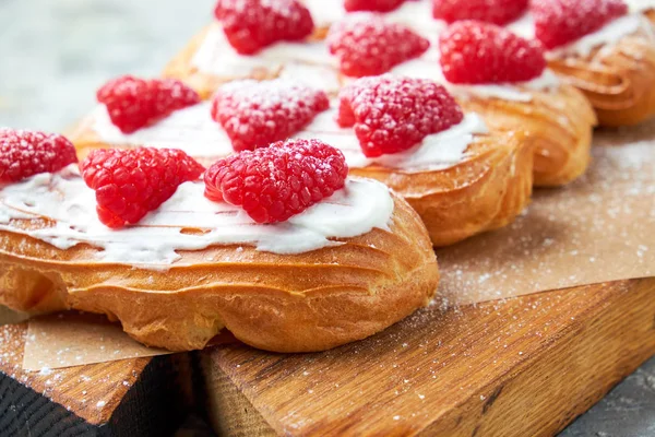 Cake eclair. Gray textured background. Beautiful serving dishes. Dessert. Food chain