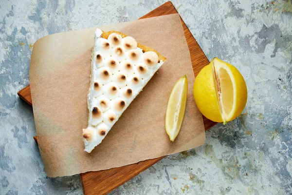 Lemon tart . Gray textured background. Beautiful serving dishes. Dessert. Food chain