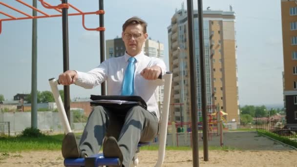 Empresario en un campo de deportes al aire libre. El concepto de un estilo de vida saludable . — Vídeo de stock