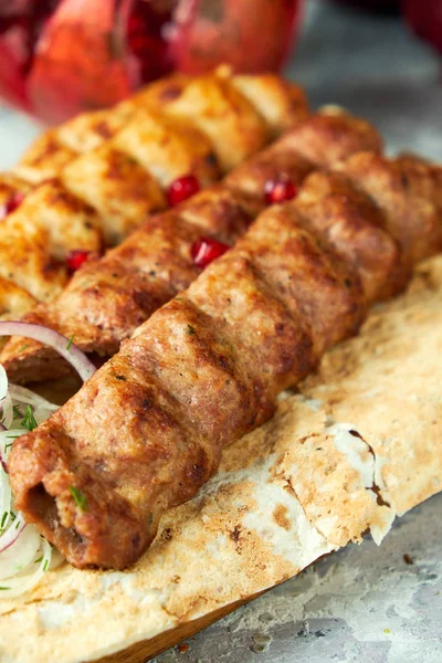 Desky z masa s barbecue a kebabem, na šedém pozadí — Stock fotografie