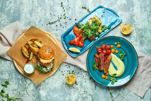 stock image Three dishes with meat burger with grilled vegetables