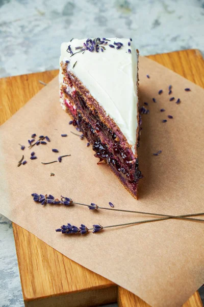 Lavender cake. Gray textured background. Beautiful serving dishes. Dessert. Food chain