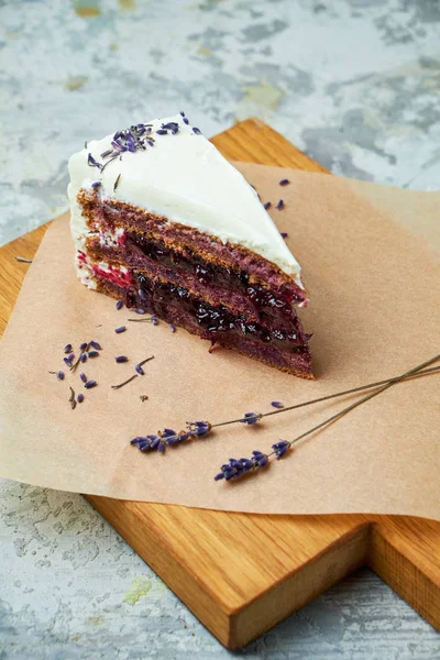 Lavender cake. Gray textured background. Beautiful serving dishes. Dessert. Food chain