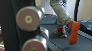 Spor salonunda koşu bandında bir adam. Sağlıklı ve aktif yaşam tarzı.