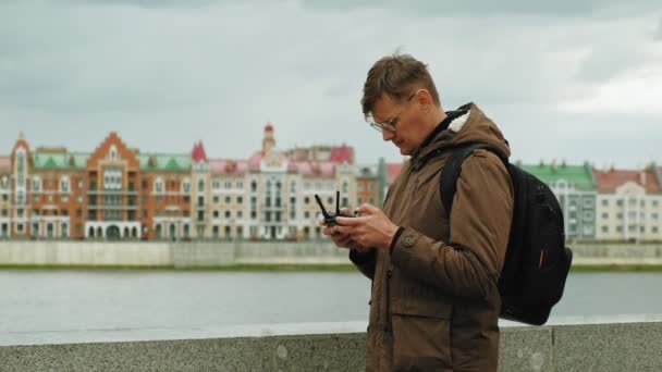 Człowiek kontroluje drona na zewnątrz. — Wideo stockowe