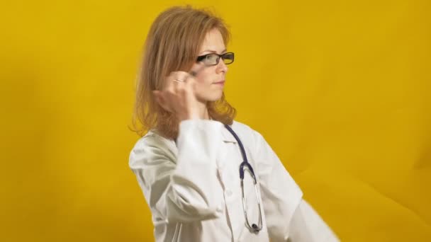 Young woman doctor. Yellow background. The concept of medicine. — 비디오