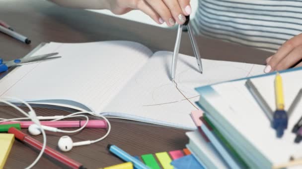 Una adolescente con gafas está sentada en un escritorio de la escuela. concepto de aprendizaje — Vídeo de stock