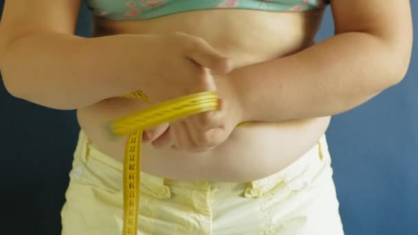 Gordura mulher barriga closeup no fundo azul — Vídeo de Stock