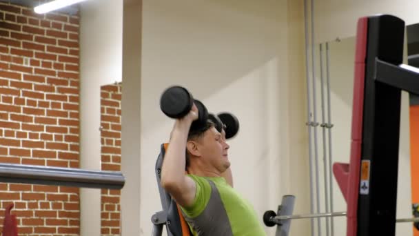 A Man Doing A Bench Press With Dumbbells Sitting With A Straight
