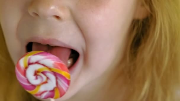 Little girl with a lollipop on a Yellow background. Close up portrait — Stock Video