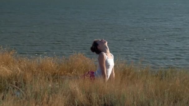 Mujer joven haciendo deportes al aire libre, yoga — Vídeos de Stock