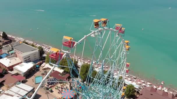 Ferris wheel on the seashore. Aerial shot — Stock Video
