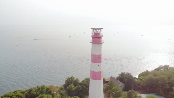 Flying around the lighthouse on the seashore. Aerial shot — Stock Video