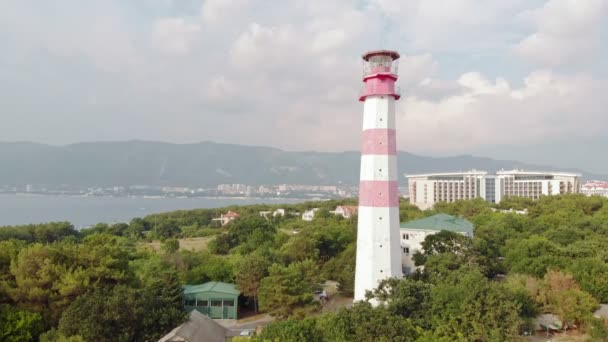 Volando alrededor del faro en la orilla del mar. Disparo aéreo — Vídeos de Stock