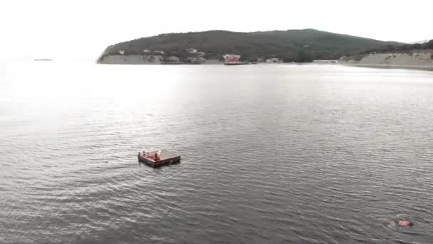 Des enfants joyeux sautent dans la mer depuis un radeau. Plan aérien — Video