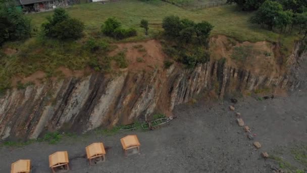 Vuelo sobre una playa rocosa en el mar al amanecer. Disparo aéreo — Vídeos de Stock