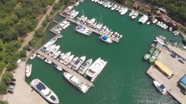 Flying over the pier with yachts in the sea . Aerial shot — Stock Video