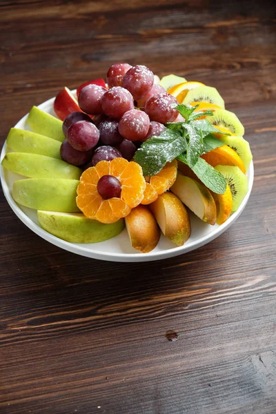 Sliced fruits on a white plate . catering menu — Stock Photo, Image