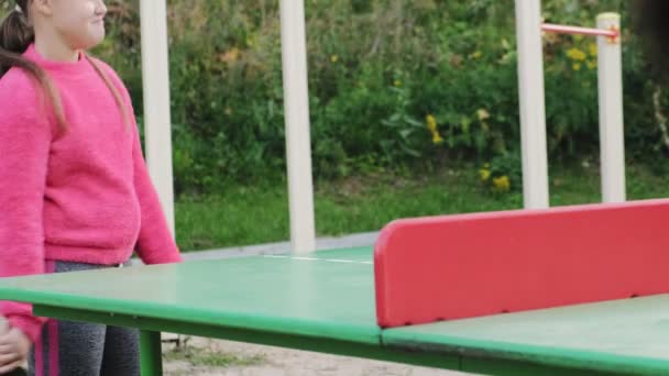 Adolescente chica jugando al tenis de mesa al aire libre — Vídeo de stock