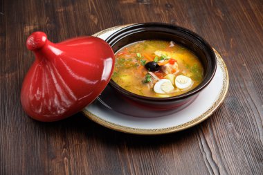 Kırmızı kapaklı bir tencerede balık çorbası. catering menüsü