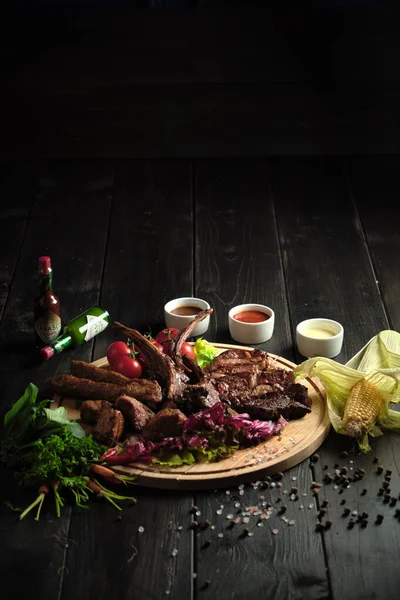 Meat on the bone on a wooden board . catering menu Stock Image
