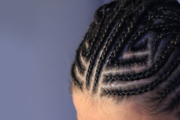 background of African braids, background for text, close-up of plaits, youth hairdressers hairdressers, master's work, plaiting braids