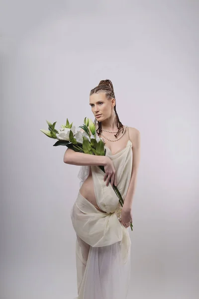 girl with exotic hairdo on white background, flowers lily, white dress, greek style, african hairstyle