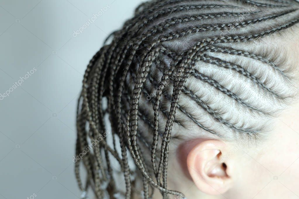 background of African braids, background for text, close-up of plaits, youth hairdressers hairdressers, master's work, plaiting braids