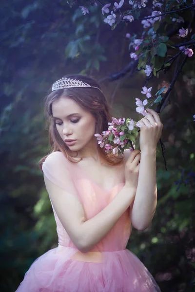 Fille dans une robe rose dans un jardin de fleurs — Photo