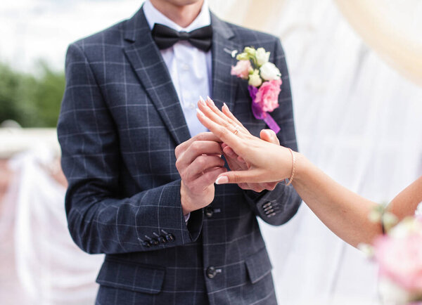 Wedding. Hands of the newlyweds with rings