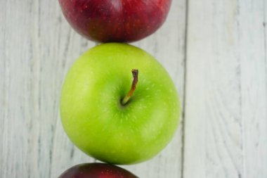 Ahşap arka plan doku üzerinde kırmızı ve yeşil elma. Sağlıklı Gıda 