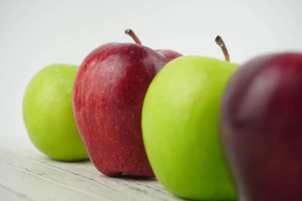 Ahşap arka plan doku üzerinde kırmızı ve yeşil elma. Sağlıklı Gıda 