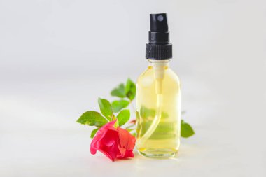 Çiçeklerin özü beyaz bir arka planda güzel bir cam kavanozda