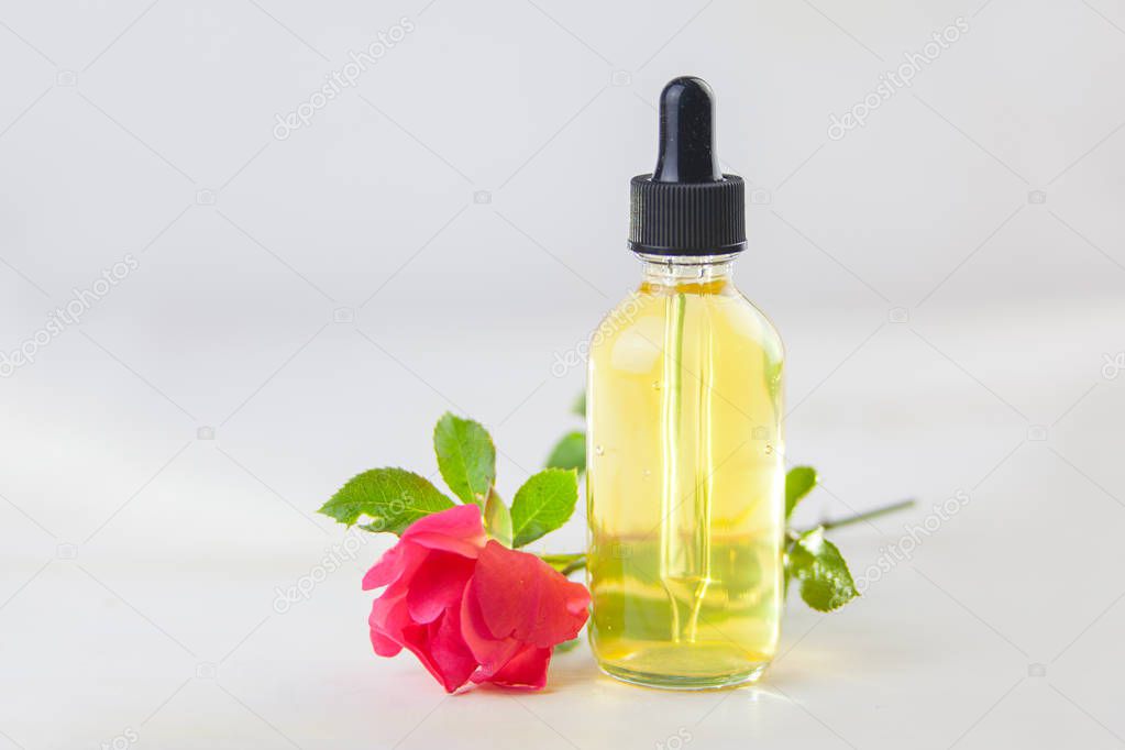 Essence of flowers on a White background in a beautiful glass jar