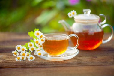 green tea with chamomile in beautiful cup clipart