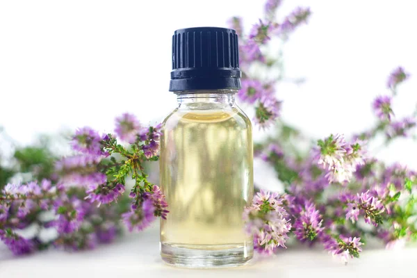 Calluna ätherisches Öl in schöner Flasche auf weißem Hintergrund — Stockfoto
