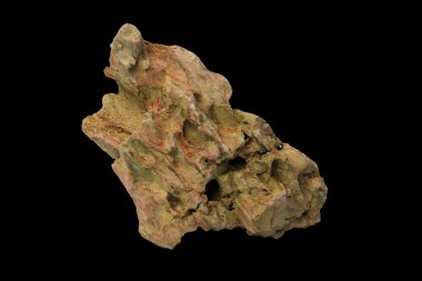 Rough dragon stone rock deep crevices and a naturally eroded surface isolated on a black background with clipping path