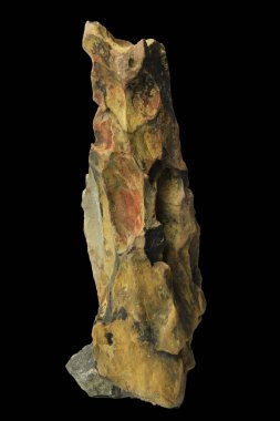 Vertical jagged dragon stone rock with rugged surface isolated on a black background with clipping path for aquascaping and decoration