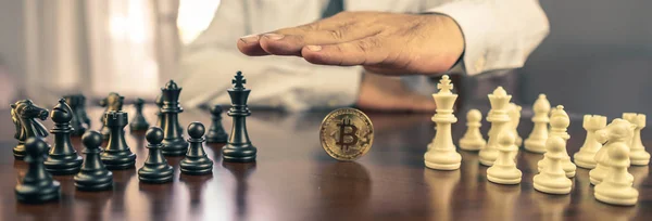 business man chess figures and bitcoin, strategy concept