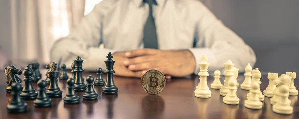 business man chess figures and bitcoin, strategy concept