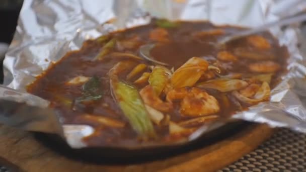 Close-up of japanese boiling vegetable dish in foil. — Stock Video