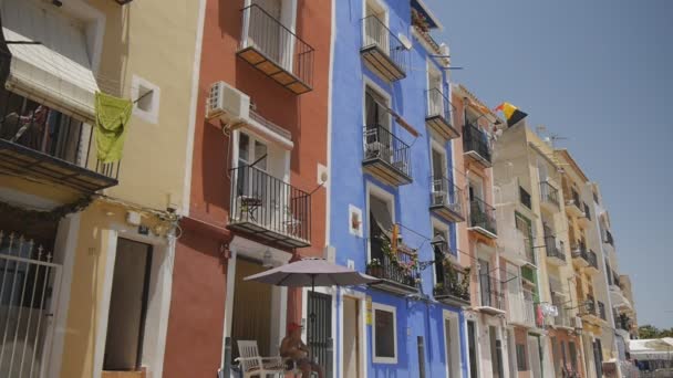 Live foto van ouderwetse Europese woongebouwen met multi-gekleurde gevels. Belgische driekleurige vlag zwaaien op een balkon. Cinemagraph. — Stockvideo