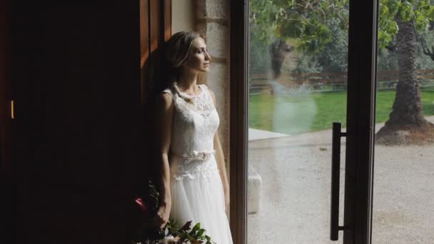 Young woman in wedding dress indoors. — Stock Video