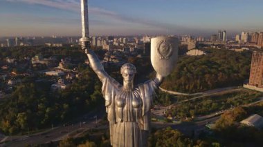 Ukrayna 'nın Ukrayna Ana Anıtı' nın Ukrayna 'daki havadan görünüşü, bir kılıç ve kalkanla. Kamera hareket ediyor, şehri ve yeşilliği gösteriyor..