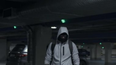 Adam suçlu yün ve otopark, underground yavaş mo kamerada bakarak hood