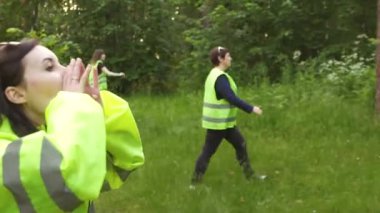 bir grup gönüllü olduğunu yeşil yelek ormanda, eksik arama