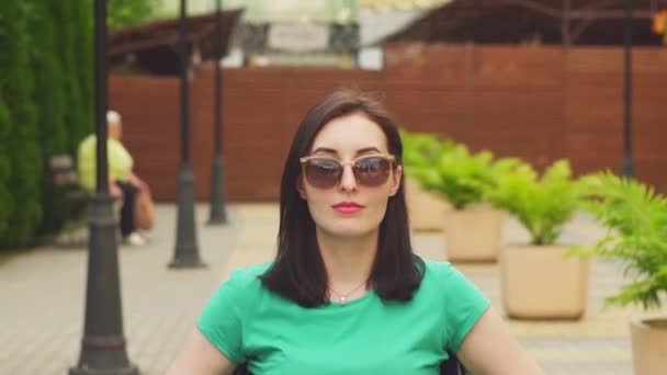 Portrait of an attractive disabled girl in a wheelchair looking at the camera — Stock Video