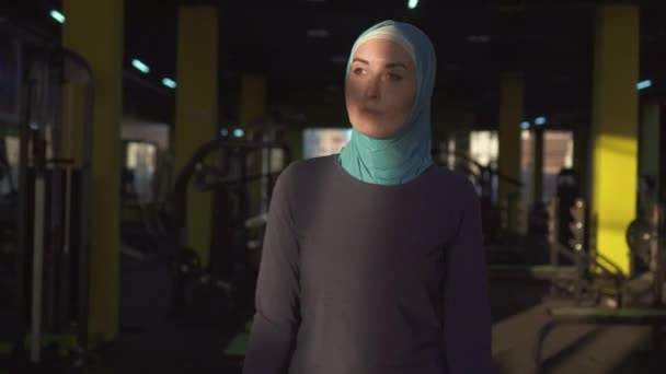 젊은 이슬람 스포츠 여자 hijab에 훈련을 위해 체육관에 왔다. Sunflare — 비디오
